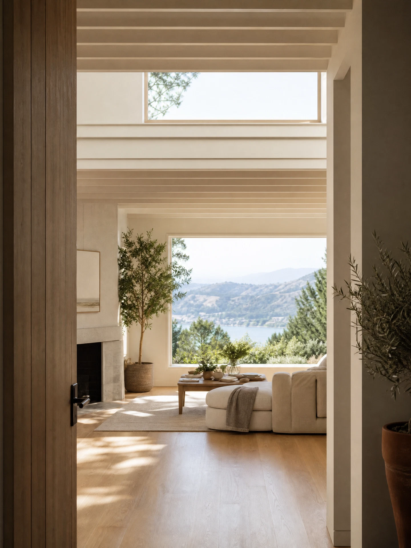 Wide editorial view of a warm, sunlit Greenbrae living room with natural oak floors and bay-hill light
